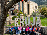 Photo from Susan's Story, The women on our tour posing under the Kruja sign