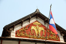 Photo from Susan's Story, a rooftop the Laotian flag and their royal symbol